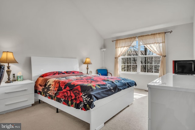 bedroom featuring light carpet and vaulted ceiling