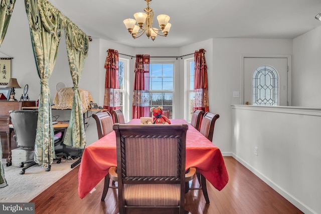 dining room with an inviting chandelier, wood finished floors, and baseboards