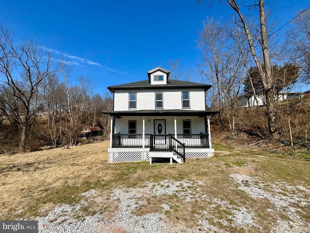 american foursquare style home featuring covered porch