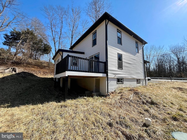 rear view of house featuring a wooden deck