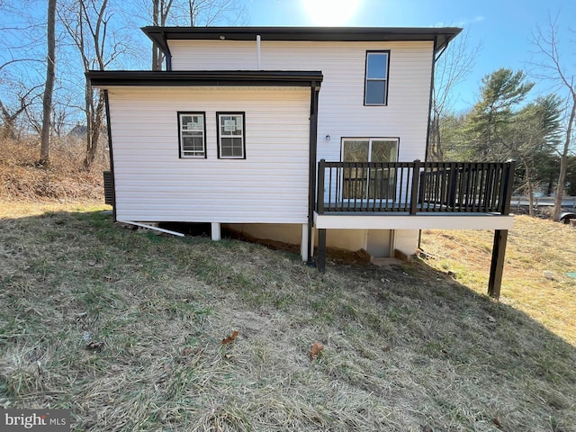 rear view of house featuring a deck