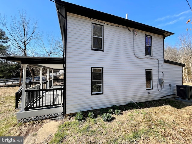 view of side of property featuring central air condition unit