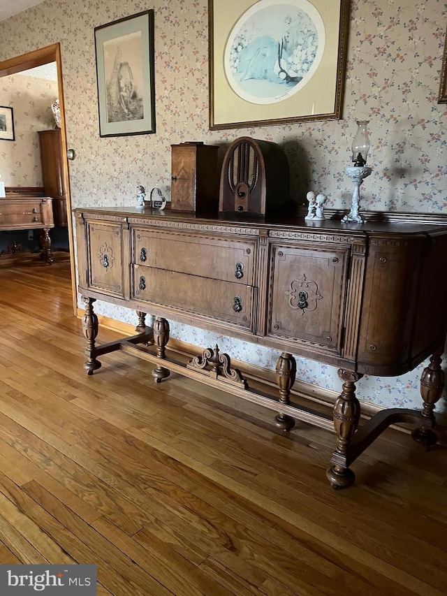 details with wood finished floors and wallpapered walls