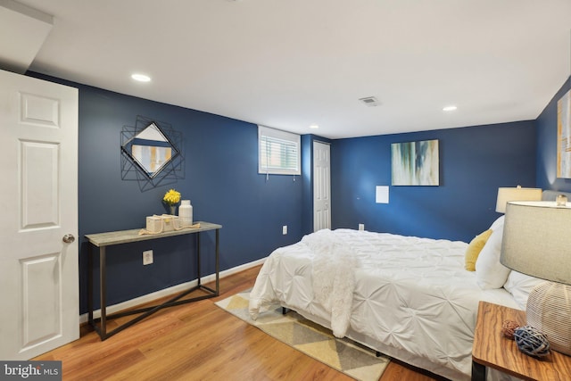 bedroom featuring recessed lighting, visible vents, baseboards, and wood finished floors