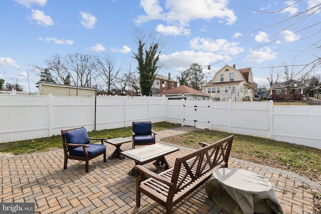 view of patio featuring a fenced backyard and a gate