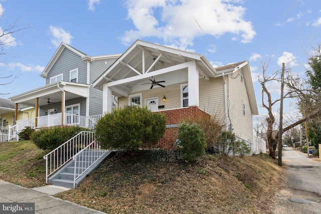 view of front of home with a porch, brick siding, stairs, and a ceiling fan