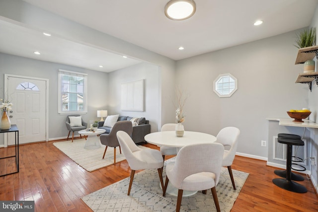 dining space featuring recessed lighting, baseboards, and light wood finished floors