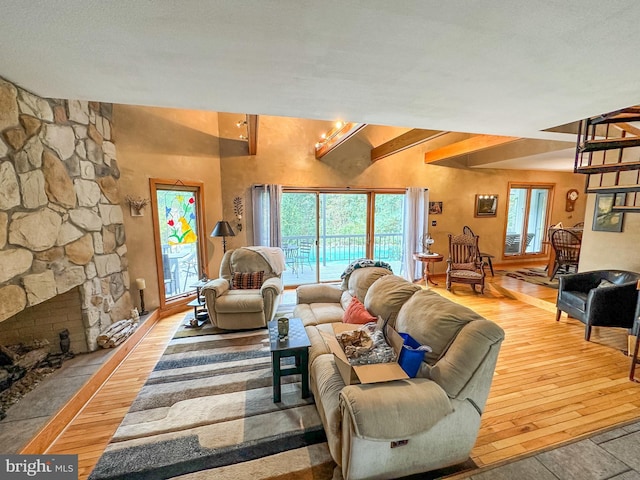 living area with a fireplace and wood finished floors