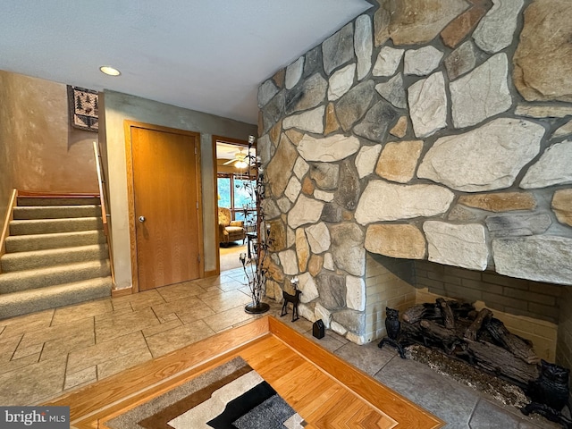 corridor featuring stairway and stone tile floors