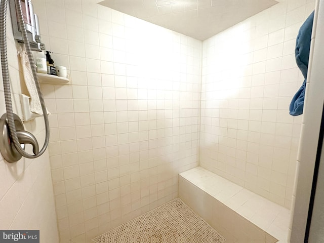 full bath with a tile shower