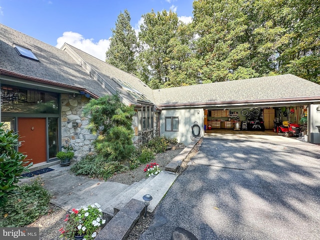 view of front of property with a garage and stone siding