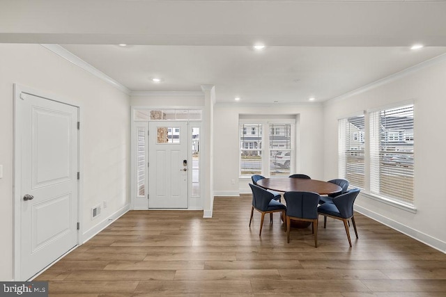 dining area featuring baseboards, recessed lighting, wood finished floors, and crown molding