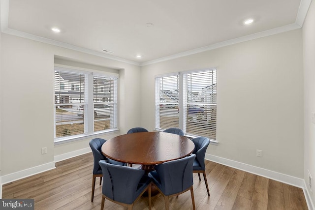 dining area featuring ornamental molding, wood finished floors, and baseboards