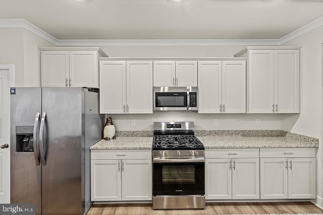 kitchen featuring stainless steel appliances, crown molding, light wood-style flooring, and light stone countertops