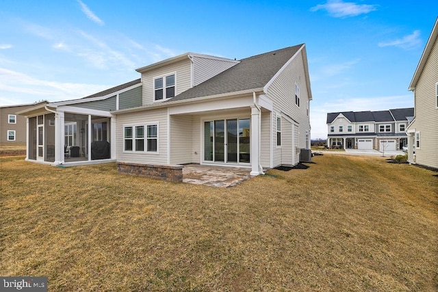 back of house featuring a sunroom, a lawn, central AC unit, and a patio