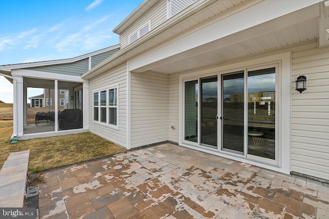 view of patio featuring a sunroom