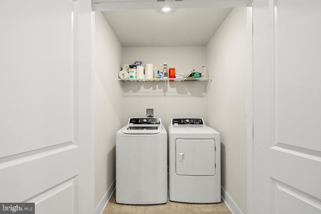 laundry room with laundry area, baseboards, and washing machine and clothes dryer