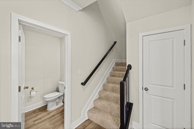 stairs with baseboards and wood finished floors