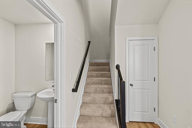 stairs featuring baseboards and wood finished floors