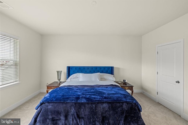 bedroom featuring light colored carpet, visible vents, and baseboards