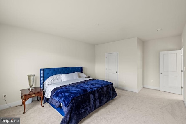 bedroom featuring carpet floors and baseboards