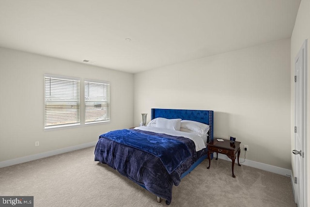 carpeted bedroom featuring visible vents and baseboards