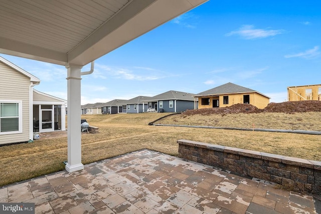 view of yard with a residential view and a patio