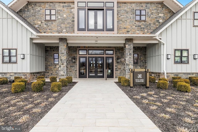 doorway to property featuring board and batten siding and french doors