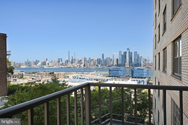 balcony featuring a view of city and a water view