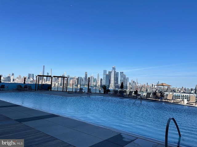 view of swimming pool featuring a view of city