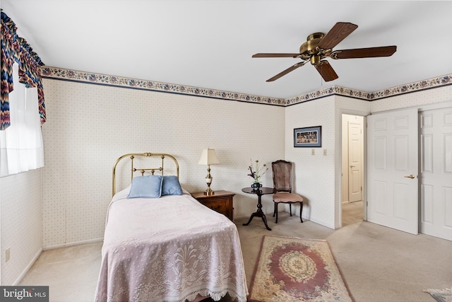 bedroom with wallpapered walls, a ceiling fan, baseboards, and carpet floors