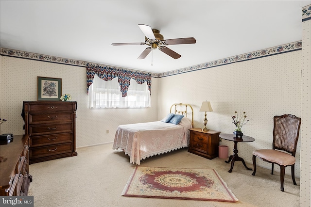 bedroom with wallpapered walls, carpet flooring, and ceiling fan