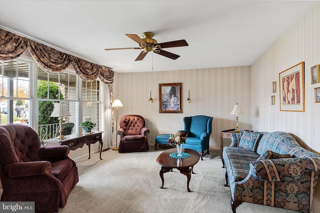 carpeted living room featuring a ceiling fan