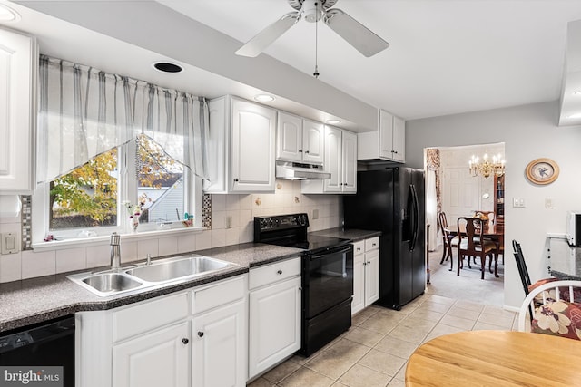 kitchen featuring under cabinet range hood, dark countertops, black appliances, and a sink