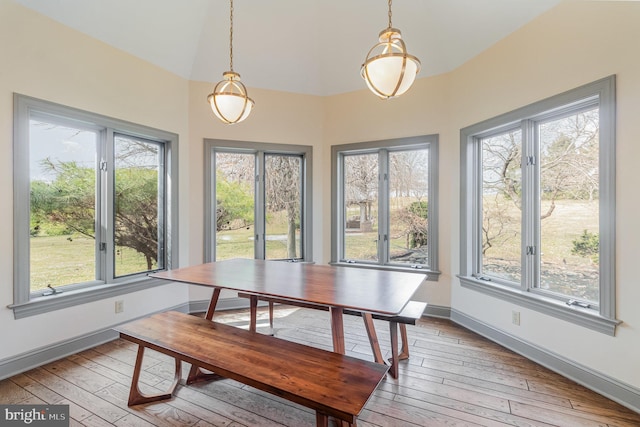 dining space featuring baseboards and light wood finished floors