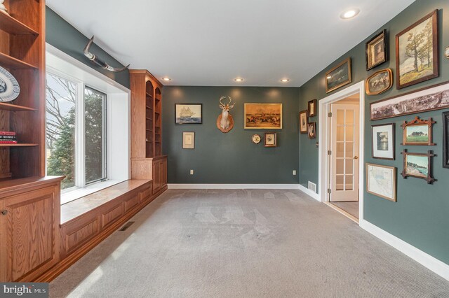 empty room featuring recessed lighting, light colored carpet, visible vents, and baseboards