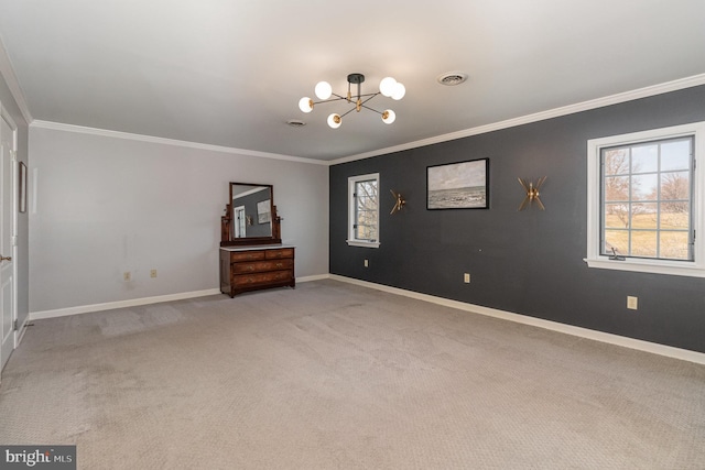 spare room with a healthy amount of sunlight, baseboards, visible vents, light carpet, and a chandelier