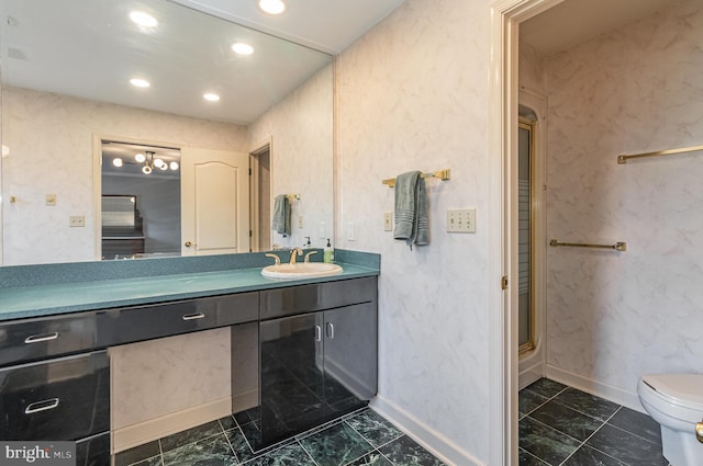 bathroom featuring vanity, toilet, recessed lighting, and marble finish floor