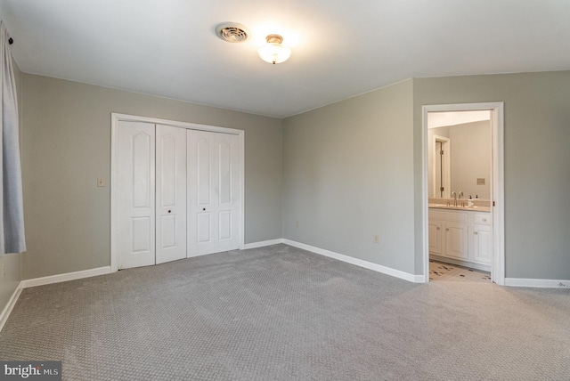 unfurnished bedroom with light colored carpet, visible vents, a closet, and baseboards