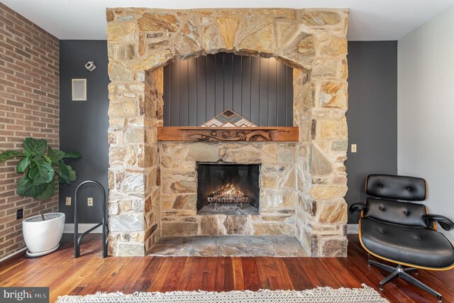 room details featuring a fireplace and wood finished floors