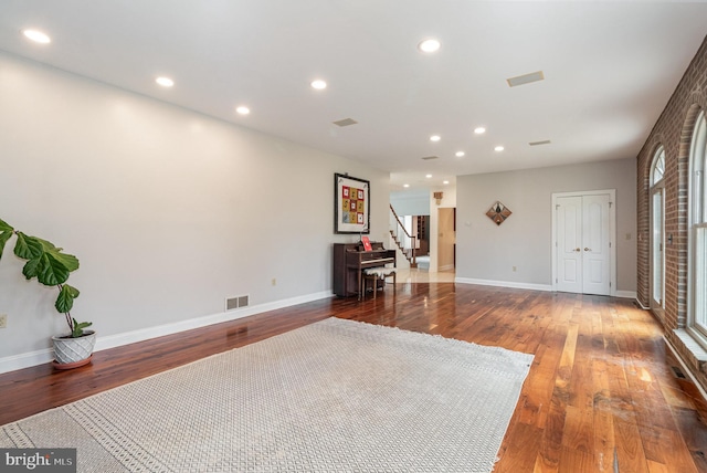 interior space featuring stairway, recessed lighting, wood finished floors, and visible vents