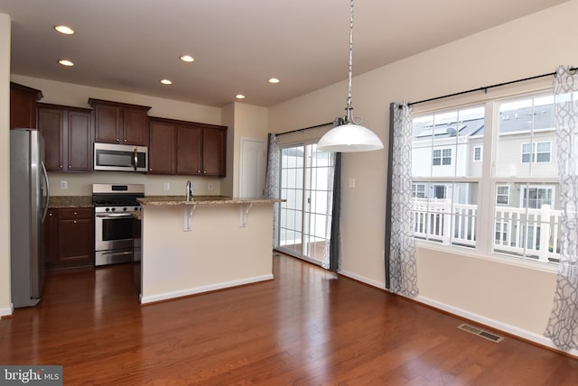 kitchen featuring dark wood finished floors, recessed lighting, visible vents, and stainless steel appliances