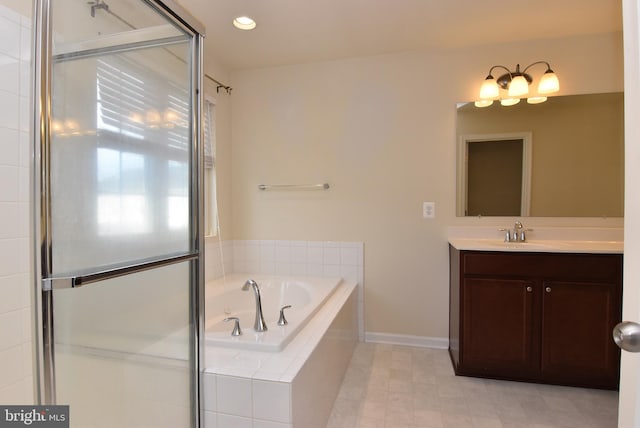 bathroom with a shower stall, baseboards, recessed lighting, a bath, and vanity