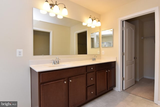 bathroom featuring double vanity, baseboards, and a sink