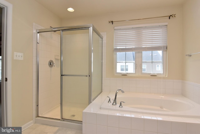 bathroom with recessed lighting, a garden tub, and a stall shower