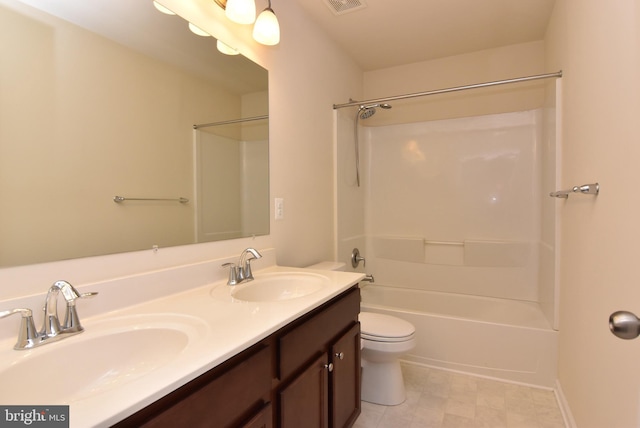 full bathroom featuring a sink, bathing tub / shower combination, toilet, and double vanity