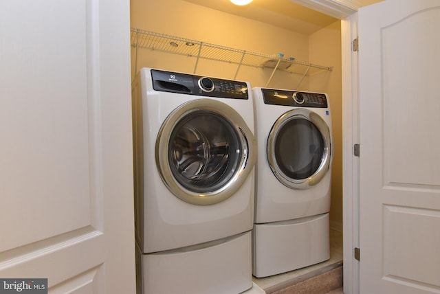 clothes washing area featuring independent washer and dryer and laundry area