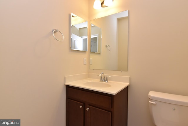 half bathroom featuring toilet and vanity