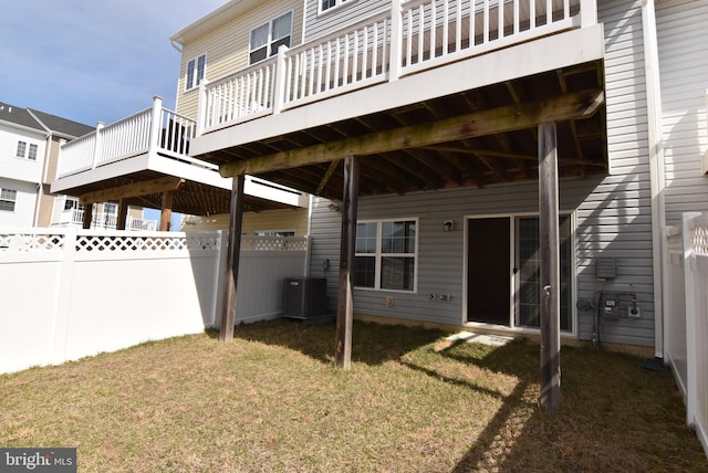 exterior space featuring central air condition unit, a yard, and fence