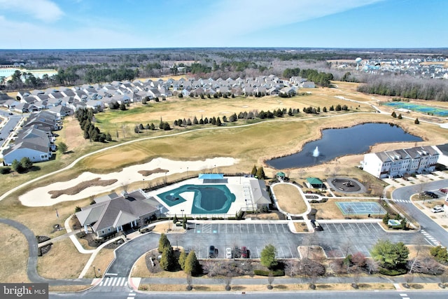 drone / aerial view featuring a residential view and a water view